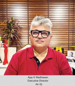 Portrait of Ajay K Wadhawan, he is wearing a red polo tshirt and there is wooden window behind him.