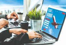 AI-optimised travel management enters the stage A person using a laptop, on the laptop screen there's plan and seems to be online platform for travel booking